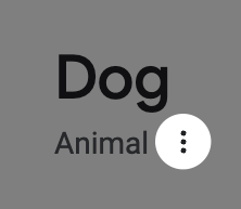 A heading that reads, 'Dog', with a subtitle that reads, 'Animal.' After the subtitle are three small vertically-stacked black dots. A filter of 50% transparent black has been applied to the entire image, with a cutout circle centered around the stacked dots, to draw the reader's attention to it. Cropped screenshot of the search result knowledge panel.