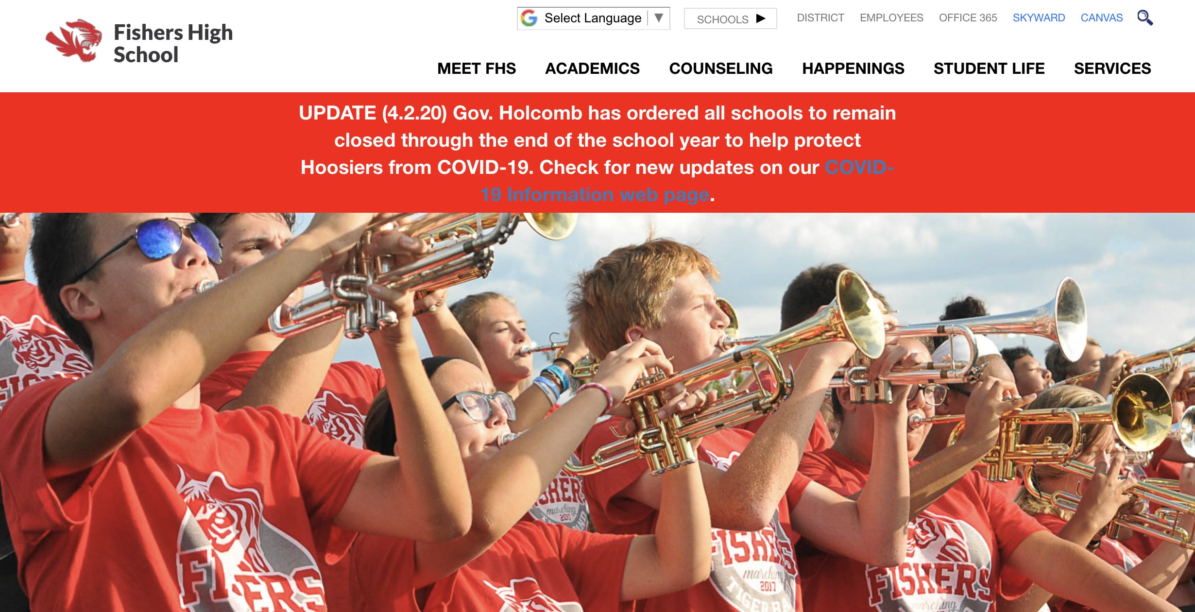 A narrow, bright red banner stacked on top of a full-width photo of the trumpet section of a high school band. The banner reads, 'Update (4.2.20) Gov. Holcomb has ordered all schools to remain closed through the end of the school year to help protect Hoosiers from COVID-19. Check for new updates on our COVID 19 Information web page.' The phrase, 'COVID-19 Information page' is set to a light blue color to indicate it is a link, making it difficult to read when placed against the bright red background.